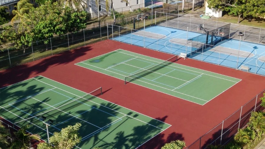 Resort sports court lighting on existing fence poles: St. Kitts Marriott