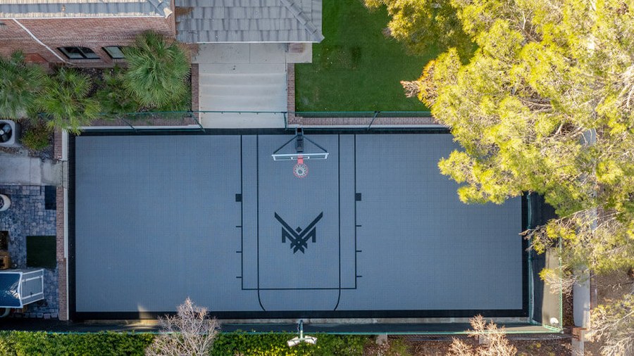 A custom backyard half-court in team colors: Maxx Crosby