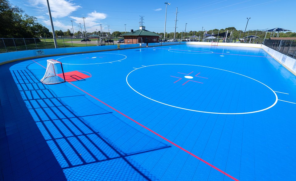 A portable ball hockey court that travels with the school: Gretzky Hockey School