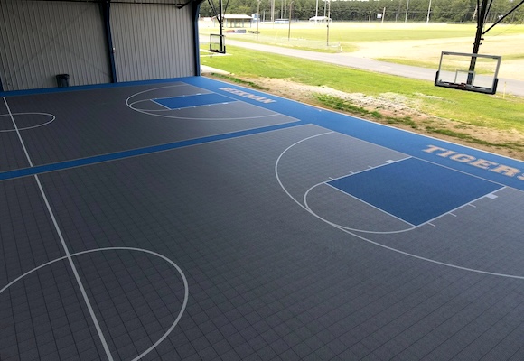 VersaCourt Game Outdoor tile in yellow with a close-up of the open grid