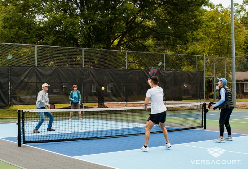 Stack of VersaCourt Pickleball Performance tiles in blue, green and red